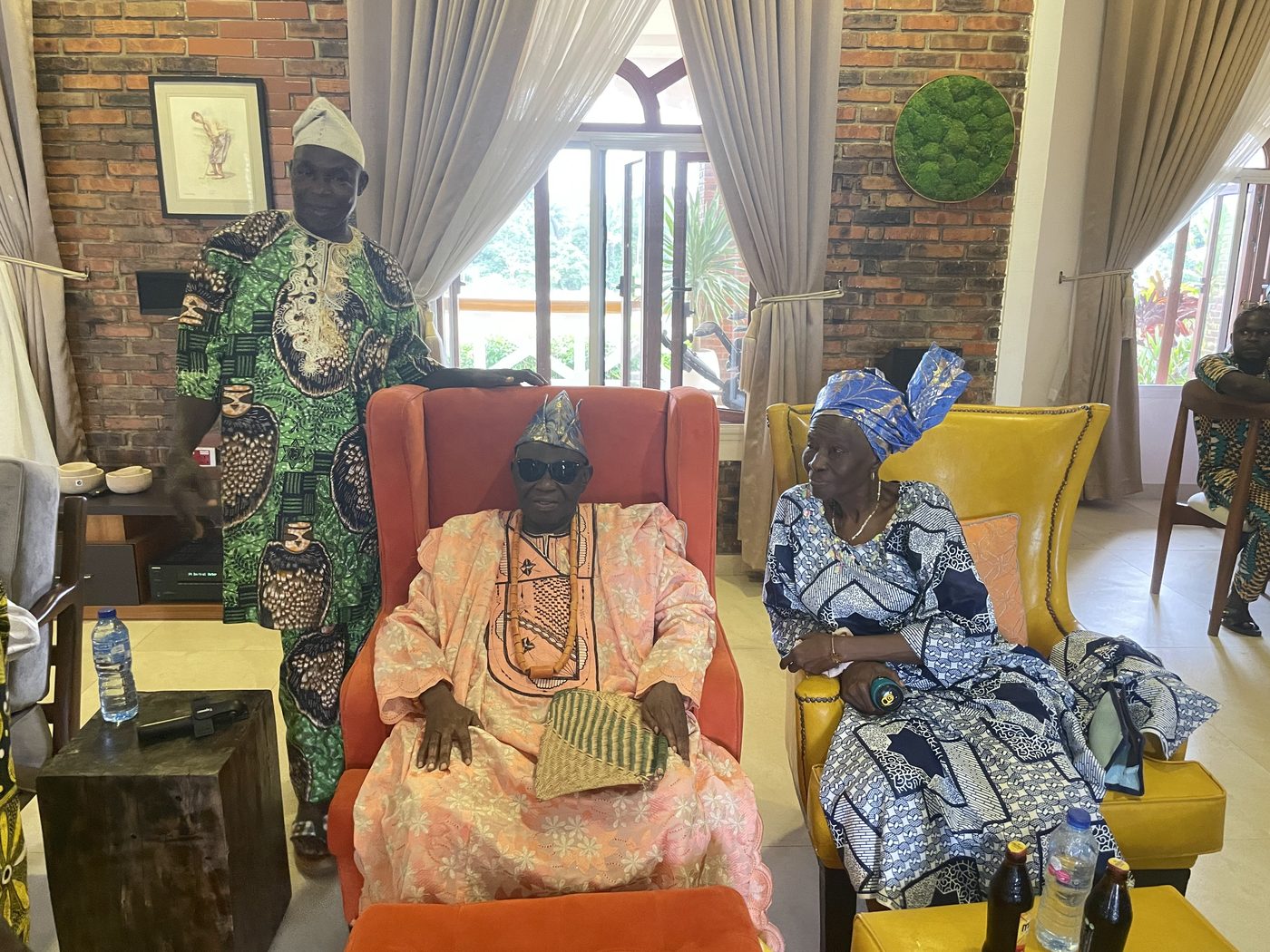 A seated chief in beaded crown with elders, guests of honour at the 2023 harvest