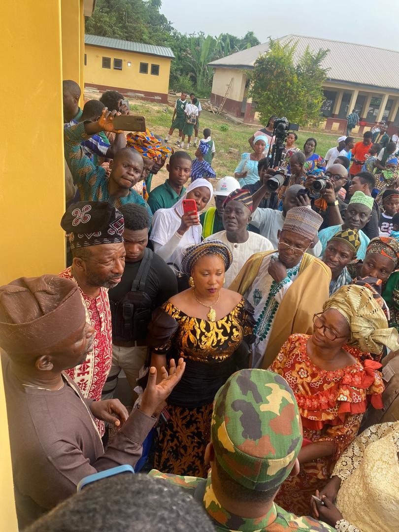 Crowd of dignitaries, press and schoolchildren at the Community Secondary School Onipe commissioning, 2024